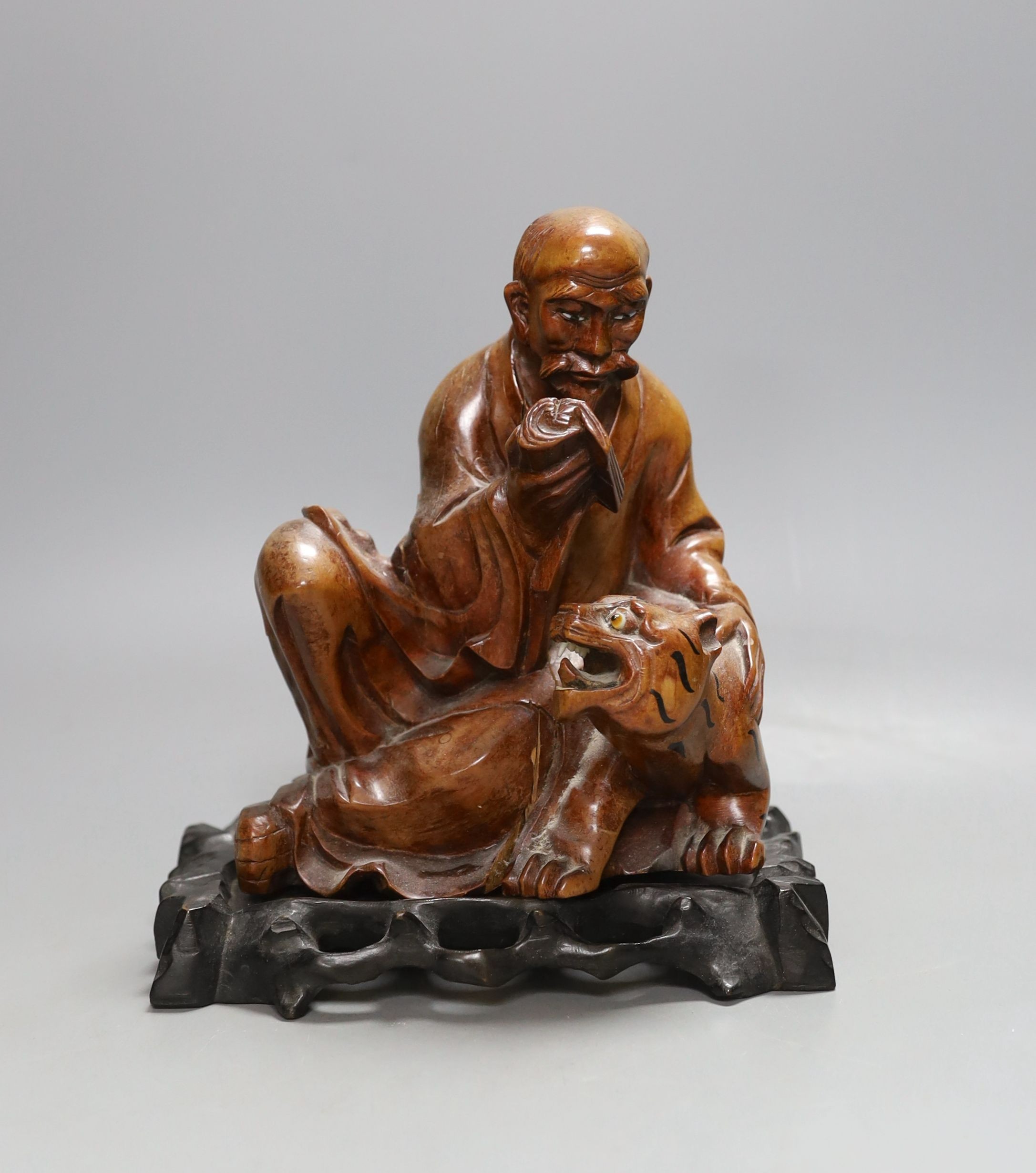 A Chinese wood group of a luohan - 21cm tall